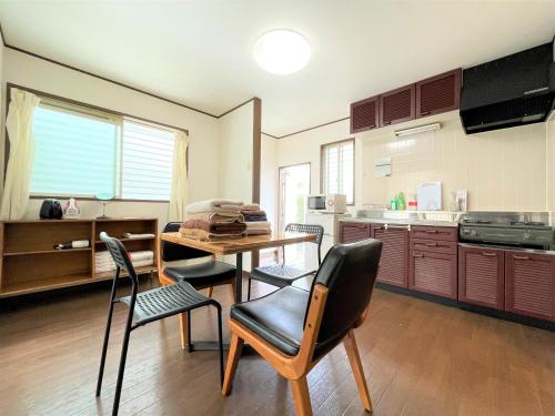 a kitchen with a table and chairs in a room at Estate F101 in Kamatachō