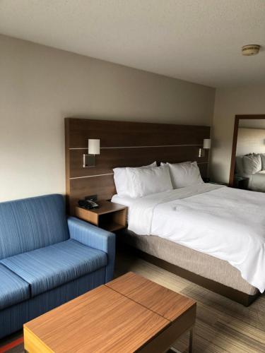 a hotel room with a bed and a couch at Holiday Inn Express Mt. Vernon by IHG in Mount Vernon