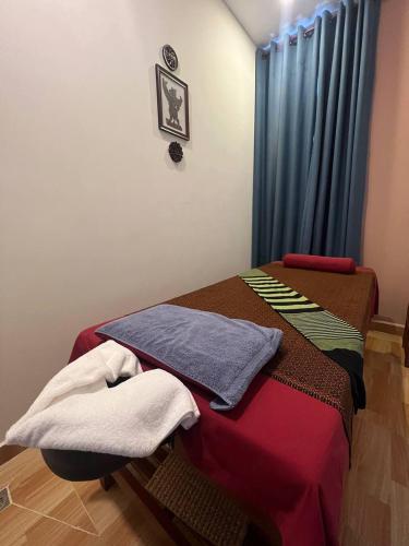 a room with a bed with towels on it at The Moon Kampot Boutique in Kampot