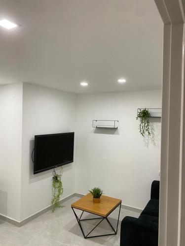 a living room with a flat screen tv on a wall at מישל נופש ,צופית תחתית 6003 in Eilat