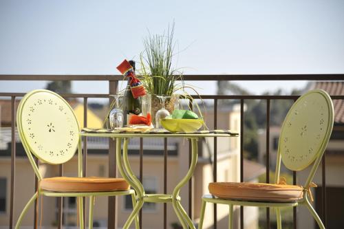 a table and two chairs with a table with food on it at Le Stanze di Patika in Tortolì