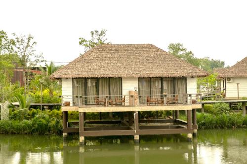 a house on a dock on a body of water at Good Time Relax Resort in Kampot