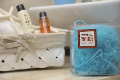 a pair of towels and a box of toothpaste at Le Stanze di Patika in Tortolì