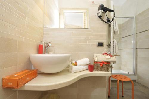 a bathroom with a sink and a shower at Le Stanze di Patika in Tortolì