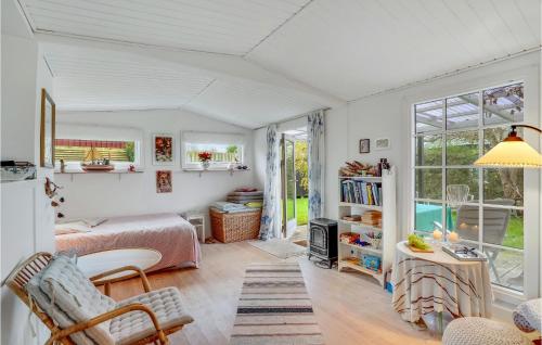 a bedroom with a bed and a room with a window at Gorgeous Home In Karrebæksminde in Karrebæksminde