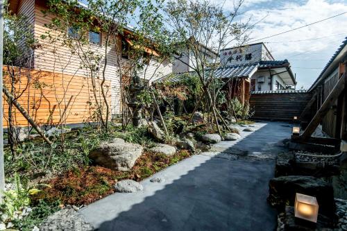 a walkway in front of a house at Nipponia 甲佐 疏水の郷 in Kosa