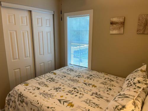 a bedroom with a bed and a window at Wilson Two Bedroom House in Historic Loveland in Loveland