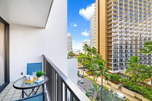 a balcony with a table and a view of a building at 7FL Waikiki Retreat with Parking, Walk to Beach in Honolulu