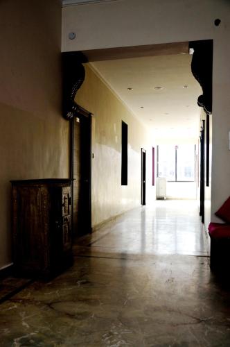 an empty hallway of a building with a large window at La Casa in Haridwār