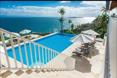 a swimming pool with a view of the ocean at Vista Mare Samana Amazing Views!! in Santa Bárbara de Samaná