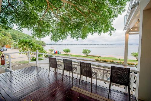 a balcony with chairs and a view of the water at Seashell Village Resort in Chao Lao Beach