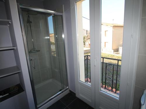 a walk in shower next to a glass door at Appartement Banyuls-sur-Mer, 3 pièces, 4 personnes - FR-1-309-4 in Banyuls-sur-Mer