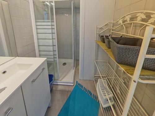 a bathroom with a sink and a shower at Appartement T3 avec Terrasse à 30m des Commerces et Plage à Ploemeur - FR-1-349-72 in Ploemeur