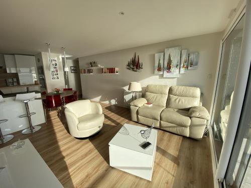 un salon avec un canapé et une table dans l'établissement Ploemeur - Appartement 3 pièces avec balcon, ascenseur et WIFI près de la plage - FR-1-349-90, à Ploemeur