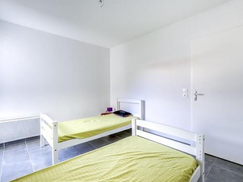 two beds in a white room with yellow sheets at Biscarrosse Plage - T2 avec Parking, Balcon et 4 Couchages - FR-1-521-92 in Biscarrosse-Plage