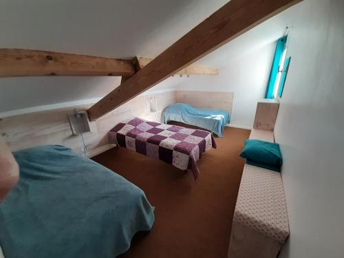 a attic room with two beds and a table at Maison Hendaye, 7 pièces, 12 personnes - FR-1-239-492 in Hendaye