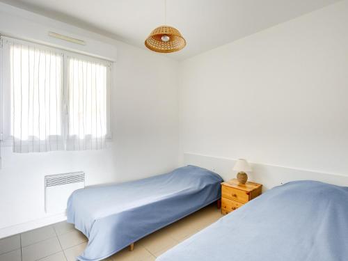 una camera con due letti e una finestra di Appartement Biscarrosse Plage, 4 pièces, 6 personnes - FR-1-521-12 a Biscarrosse-Plage