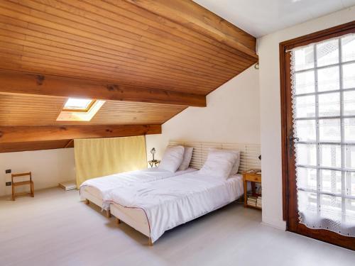 a bedroom with a large bed with a wooden ceiling at Maison Biscarrosse Plage, 4 pièces, 8 personnes - FR-1-521-94 in Biscarrosse-Plage