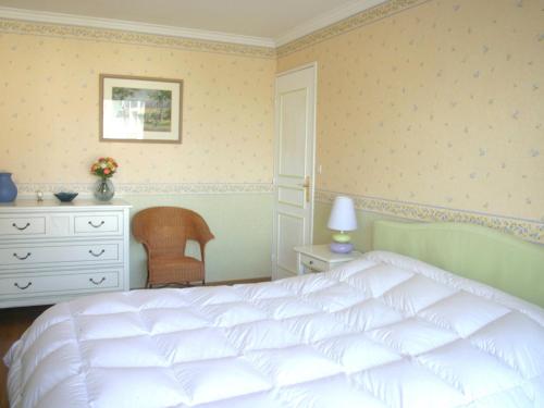 a bedroom with a white bed and a dresser at Appartement 3 pièces en front de mer avec balcons, à Cabourg, proche centre-ville. - FR-1-487-275 in Cabourg