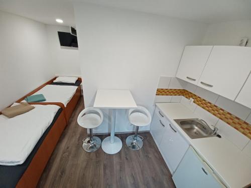 a small room with two beds and a sink at Aquas AP in Petrijanec