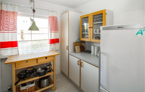 a kitchen with a white refrigerator and a wooden counter at 3 Bedroom Lovely Home In Samsø in Nordby