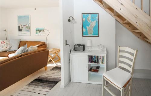 a living room with a couch and a chair at 3 Bedroom Lovely Home In Samsø in Nordby