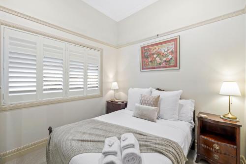 a bedroom with a bed with shoes on it at The Guesthouse Maleny in Maleny