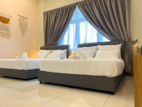 two beds in a room with a window at Skypod Residence Puchong in Puchong