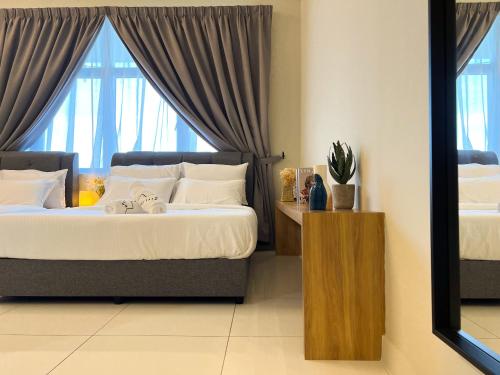 a bedroom with two beds and a large window at Skypod Residence Puchong in Puchong