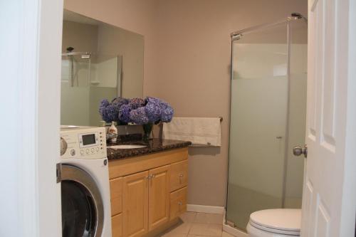 a bathroom with a washer and dryer in at Ocean Park B&B in Surrey