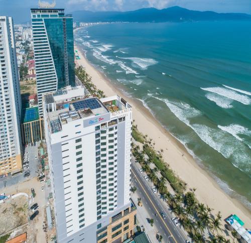 an aerial view of a beach and buildings at Rosamia Da Nang Hotel - My Khe Beachfront Luxury in Danang