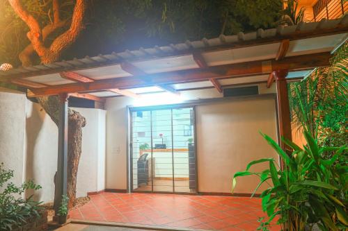 an open door to a garage in a house at The Canopy Guest House in Auroville