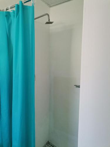 a shower with a blue curtain in a room at 53@Grens in Parys