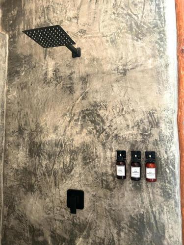 three bottles of wine sitting on top of a table at Alquimia Hotel Boutique in Tulum