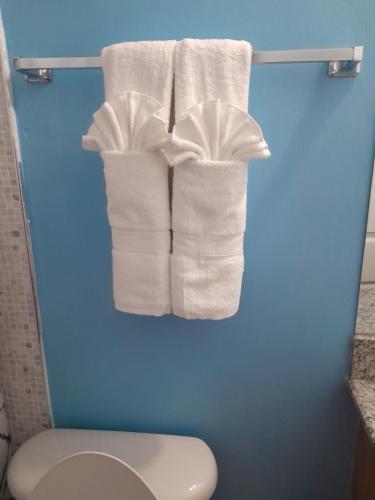 a group of white towels hanging on a rack in a bathroom at HARMONY LA VISTA in Runaway Bay