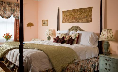 a bedroom with a large bed with white sheets and pillows at Hampton Terrace Inn in Lenox