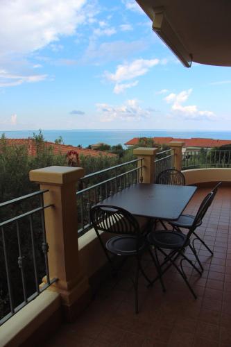 a table and chairs on a balcony with the ocean at Hotel Residence Piccolo in Parghelia