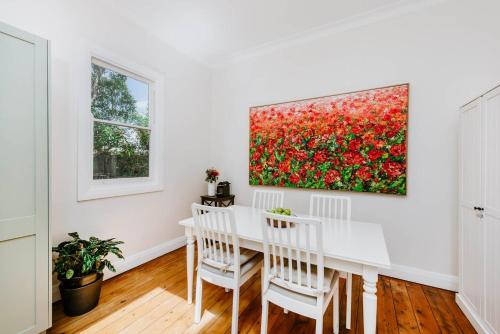 a dining room with a white table and two chairs at The Birdhouse - Your Well-deserved Country Retreat in Mudgee