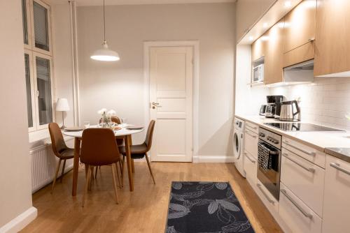 a kitchen with a table and a dining room at 2ndhomes Helsinki Center Apartment with Sauna in Helsinki