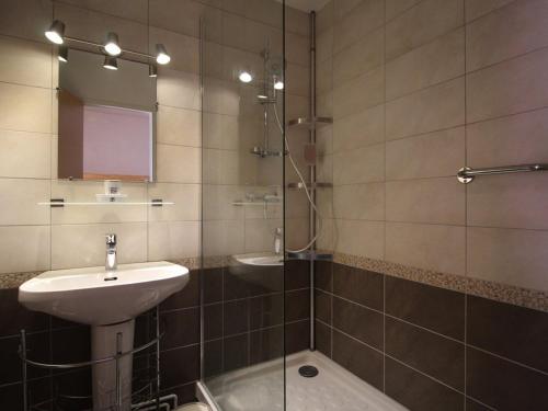 a bathroom with a sink and a glass shower at Appartement Auris, 1 pièce, 4 personnes - FR-1-297-25 in Auris