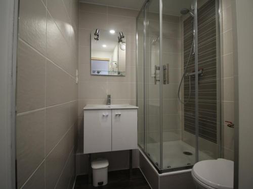 a bathroom with a shower and a sink and a toilet at Appartement Auris, 3 pièces, 6 personnes - FR-1-297-156 in Auris