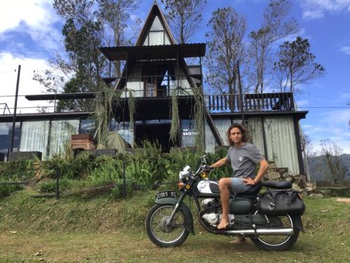 a person sitting on a motorcycle in front of a house at The Backyard Balangoda in Balangoda