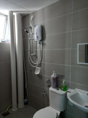 a bathroom with a shower and a toilet and a sink at SAFIYYA HOMES MERU RAYA - WIFI/NETFLIX in Ipoh