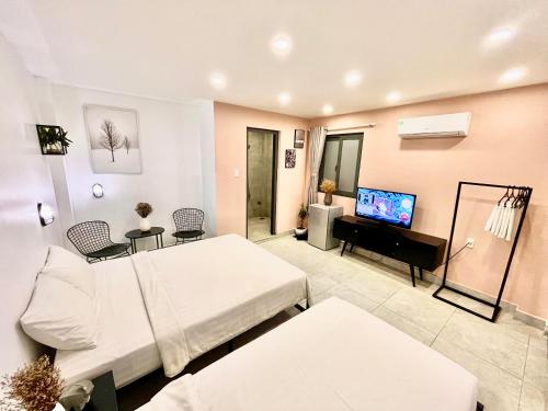 a large room with a bed and a television at MIDMOST Boutique Hostel in Can Tho
