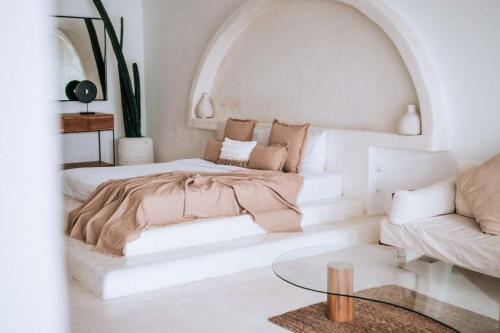 a living room with a bed and a couch at Hotel Sages in Canggu
