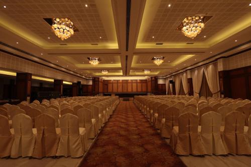a banquet hall with rows of chairs and chandeliers at Hotel Cenneys Gateway in Salem