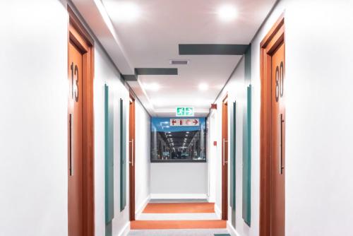a corridor in an office building with doors open at 1 Albert Studio Apartment in Cape Town