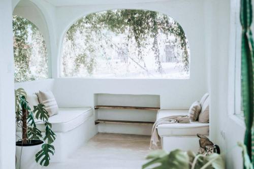 a living room with a window and a couch at Hotel Sages in Canggu