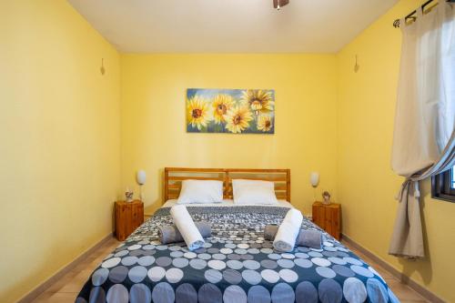 ロス・クリスティアーノスにあるFeel like home Flat Los Cristianos by LoveTenerifeのベッドルーム1室(ベッド1台付)が備わります。壁には絵画が飾られています。