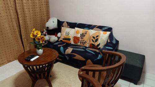 a living room with a couch and a table at Snoopy homestay Two Bedroom in Batu Pahat